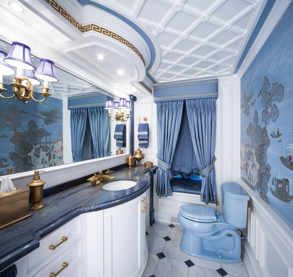 Photo of a large traditional master bathroom in New York with furniture-like cabinets, white cabinets, a bidet, white walls, ceramic floors, an undermount sink, granite benchtops, multi-coloured floor and blue benchtops.