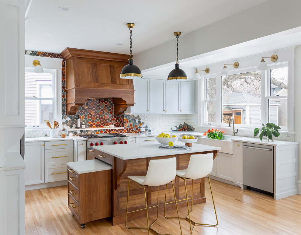 Example of a large transitional u-shaped light wood floor and beige floor eat-in kitchen design in Minneapolis with a farmhouse sink, recessed-panel cabinets, blue cabinets, quartz countertops, multicolored backsplash, ceramic backsplash, stainless steel appliances, an island and white countertops