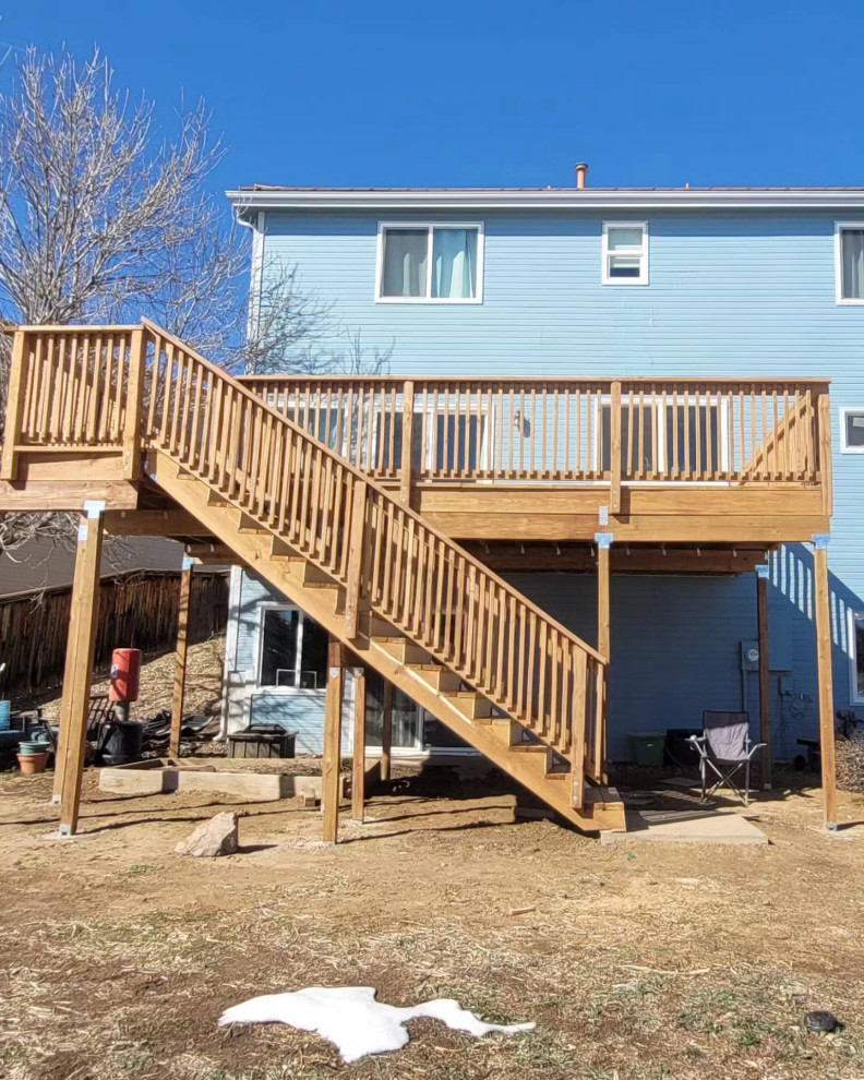 Deck - backyard second story wood railing deck idea in Denver with no cover