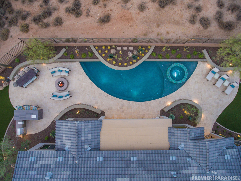 Mid-sized modern pool in Phoenix.