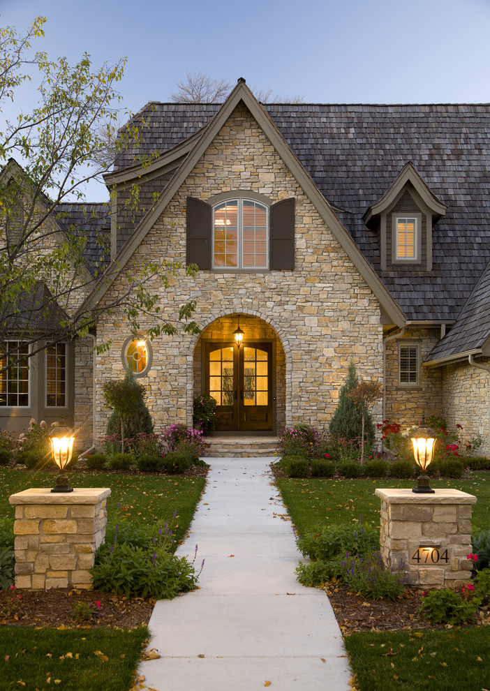 This is an example of a traditional two-storey exterior in Minneapolis with stone veneer.