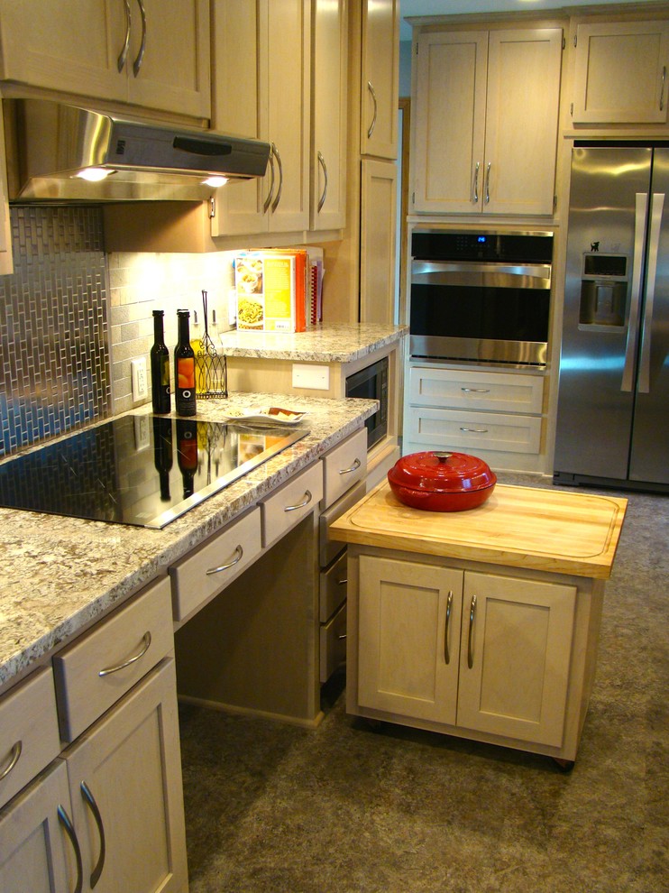 This is an example of a small arts and crafts galley kitchen pantry in Minneapolis with an undermount sink, shaker cabinets, light wood cabinets, granite benchtops, metallic splashback, stone tile splashback, stainless steel appliances, linoleum floors and no island.