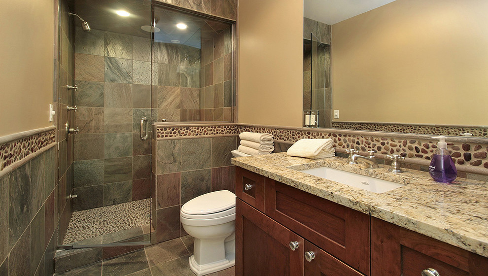Design ideas for a large traditional 3/4 bathroom in Phoenix with shaker cabinets, dark wood cabinets, an alcove shower, a one-piece toilet, multi-coloured tile, slate, beige walls, slate floors, an undermount sink and granite benchtops.