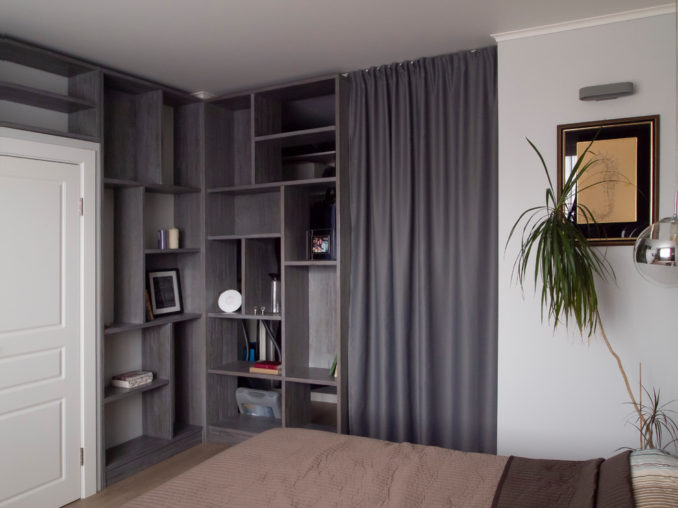 This is an example of a mid-sized contemporary master bedroom in Moscow with grey walls, laminate floors and beige floor.