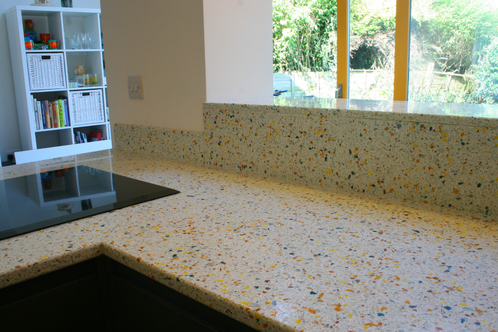 Small modern kitchen in Gloucestershire with flat-panel cabinets, grey cabinets, recycled glass benchtops, a peninsula and yellow benchtop.