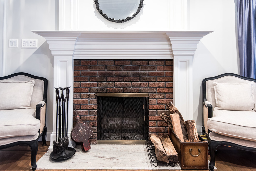 Inspiration for a mid-sized traditional formal open concept living room in Atlanta with white walls, light hardwood floors, a standard fireplace, a brick fireplace surround and no tv.