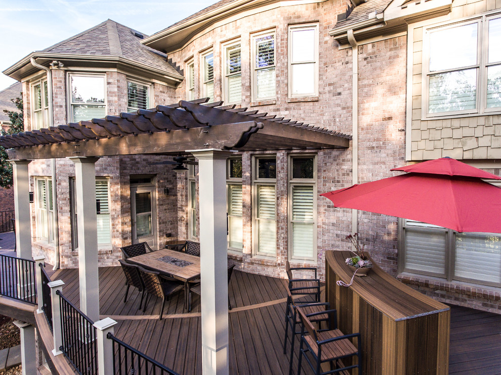 Inspiration for a large arts and crafts backyard deck in Atlanta with an outdoor kitchen and a pergola.