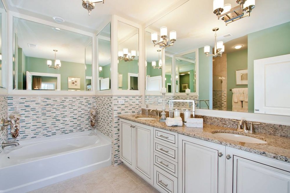 Large transitional master multicolored tile and matchstick tile travertine floor alcove bathtub photo in Chicago with raised-panel cabinets, white cabinets, green walls, an undermount sink and granite countertops