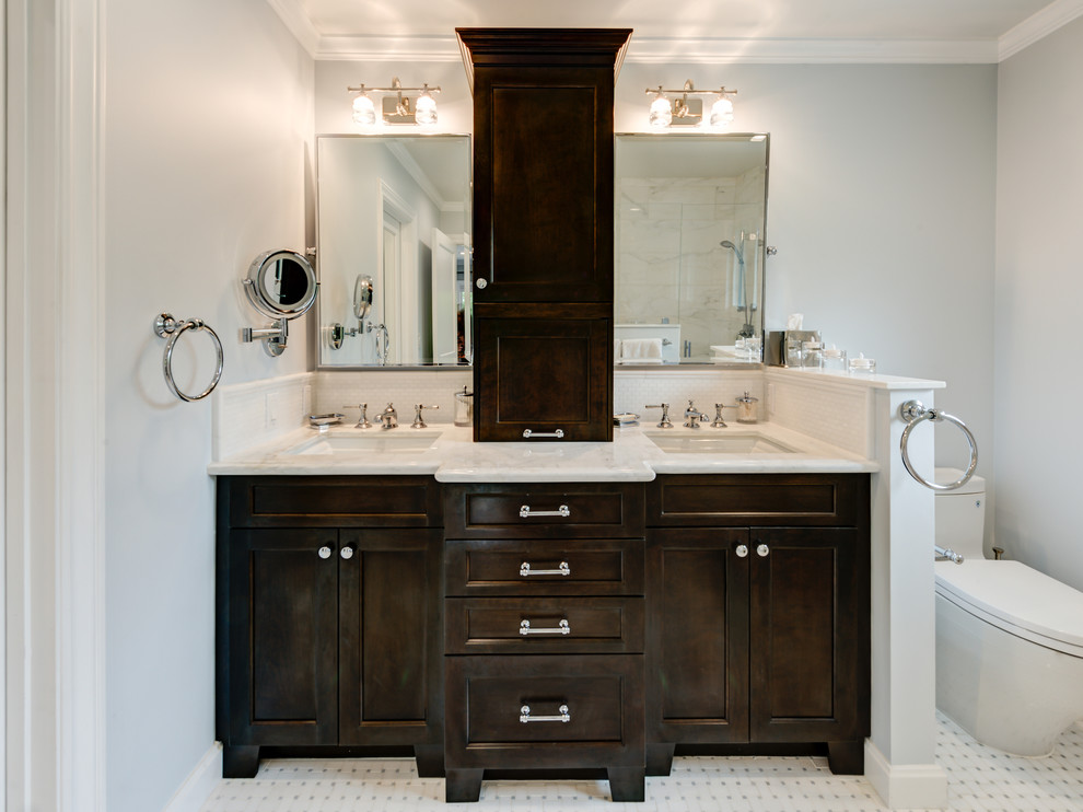This is an example of a mid-sized traditional 3/4 bathroom in San Francisco with shaker cabinets, brown cabinets, a corner tub, an alcove shower, a one-piece toilet, black and white tile, grey walls, ceramic floors, a drop-in sink, engineered quartz benchtops, white floor and a sliding shower screen.