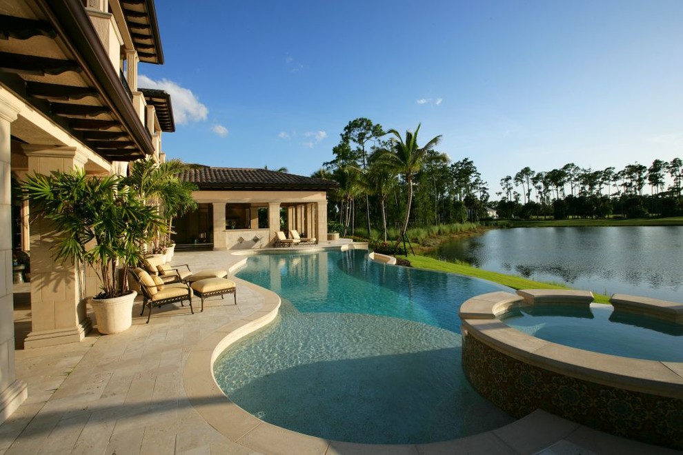 Inspiration for a mediterranean backyard custom-shaped infinity pool in Miami.