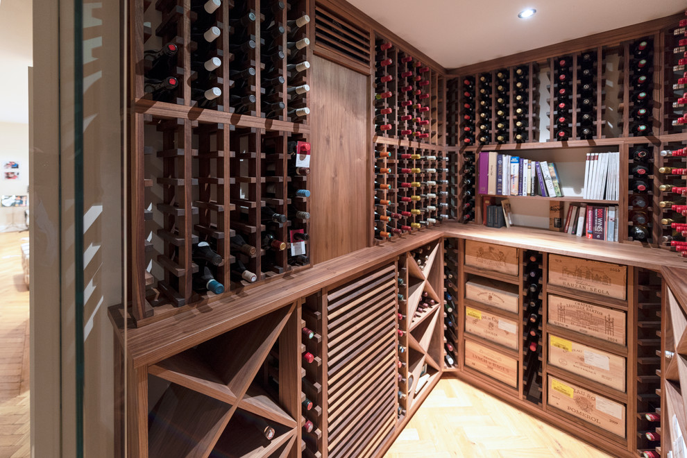 Inspiration for a small transitional wine cellar in Other with light hardwood floors, storage racks and beige floor.