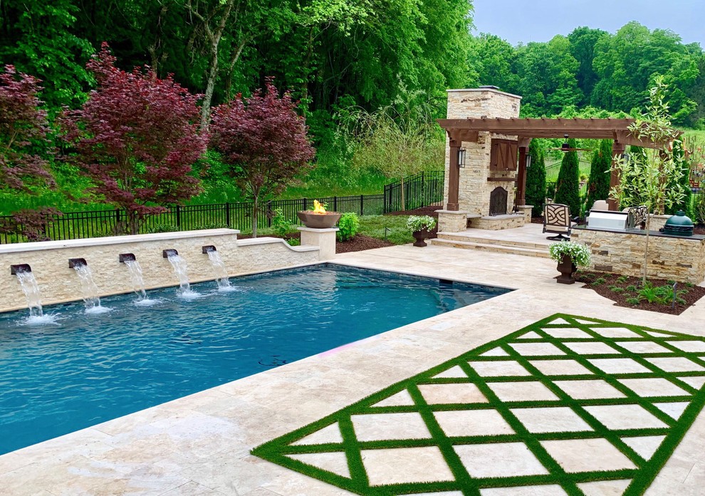 Photo of a mid-sized transitional backyard rectangular pool in Nashville with natural stone pavers.