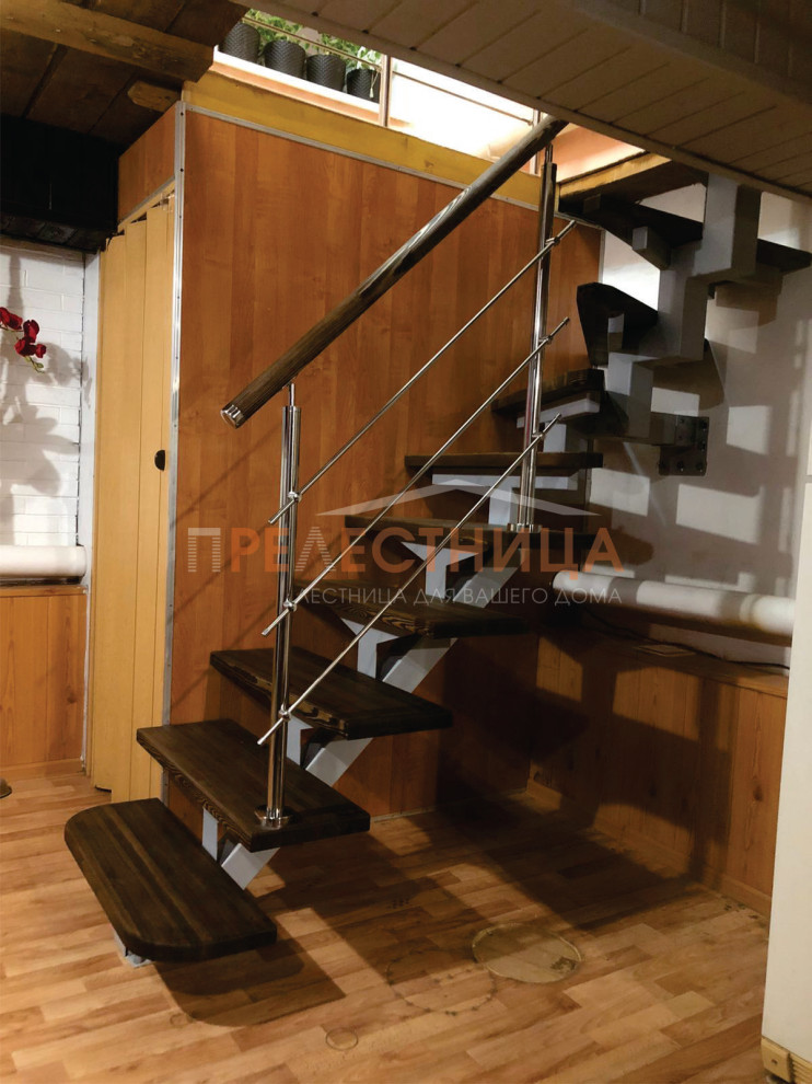 Aménagement d'un petit escalier en L avec des marches en bois peint, des contremarches en métal et un garde-corps en matériaux mixtes.