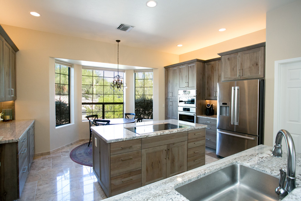 Eat-in kitchen - small rustic l-shaped ceramic tile eat-in kitchen idea in Phoenix with an undermount sink, flat-panel cabinets, gray cabinets, granite countertops, gray backsplash, ceramic backsplash, stainless steel appliances and an island