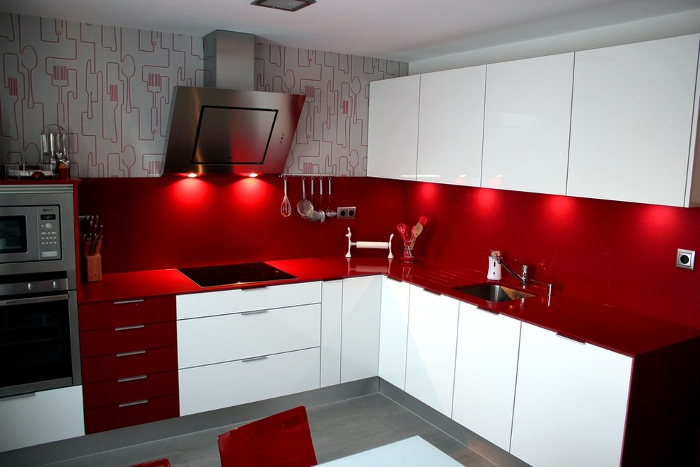 This is an example of a mid-sized contemporary l-shaped eat-in kitchen in Madrid with flat-panel cabinets, white cabinets and no island.