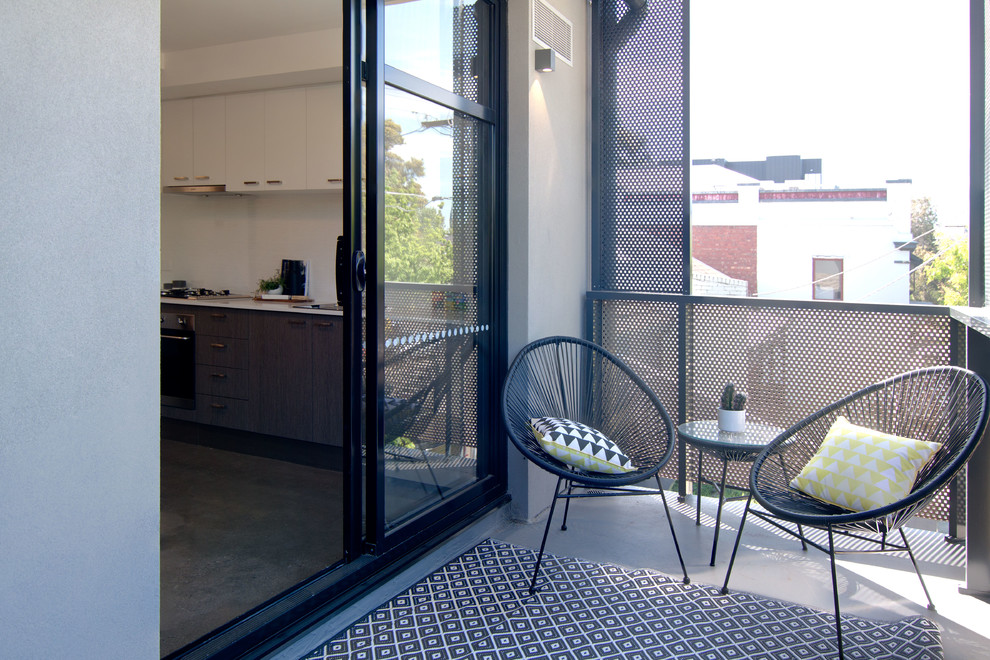 This is an example of a mid-sized industrial balcony in Other with metal railing.