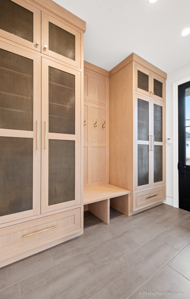 Example of a large transitional porcelain tile and gray floor mudroom design in Chicago with white walls and a dark wood front door