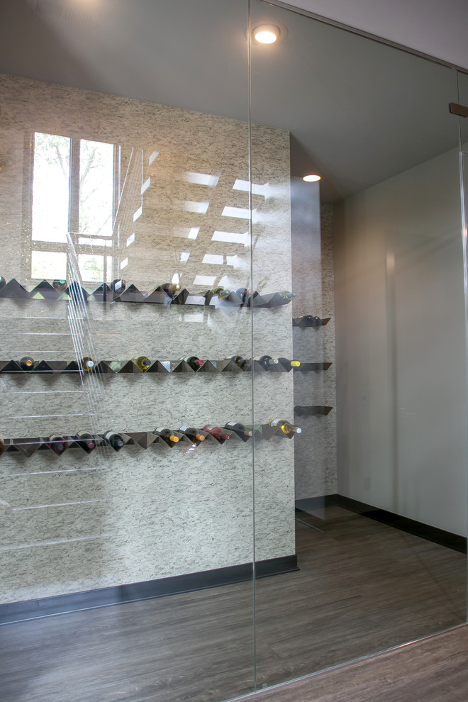 Design ideas for a large contemporary wine cellar in Milwaukee with vinyl floors, storage racks and grey floor.