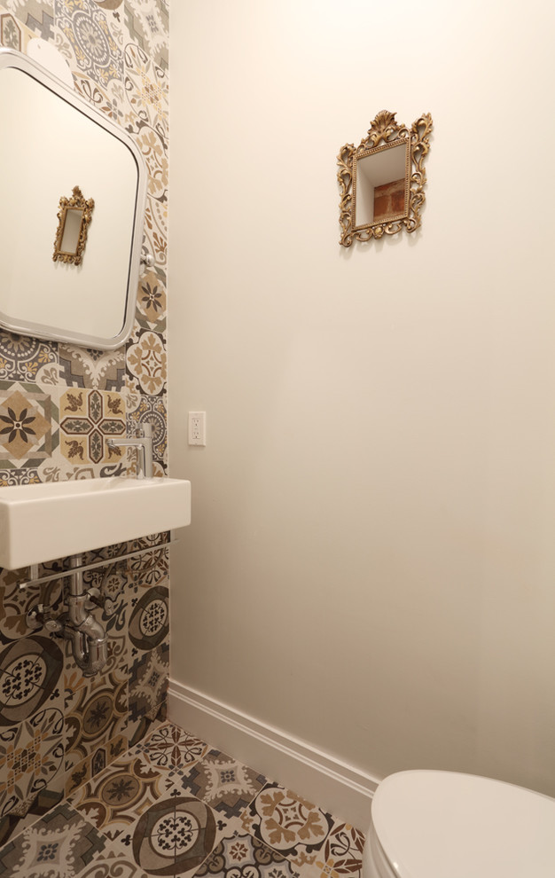 Small mediterranean powder room in New York with a one-piece toilet, cement tile, white walls, cement tiles and a wall-mount sink.