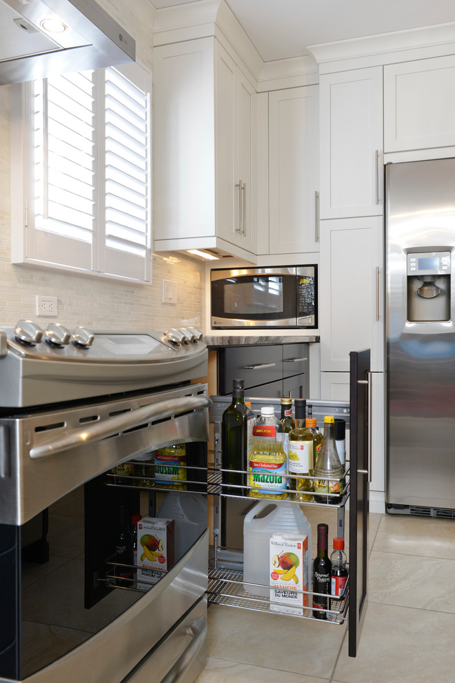 Large transitional u-shaped ceramic tile enclosed kitchen photo in Toronto with an undermount sink, flat-panel cabinets, dark wood cabinets, granite countertops, beige backsplash, matchstick tile backsplash, stainless steel appliances and an island