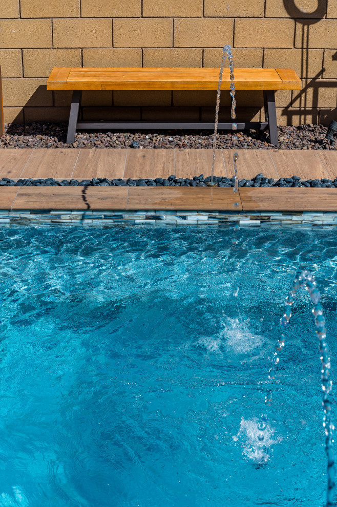 Example of a small backyard tile and rectangular pool design in Phoenix
