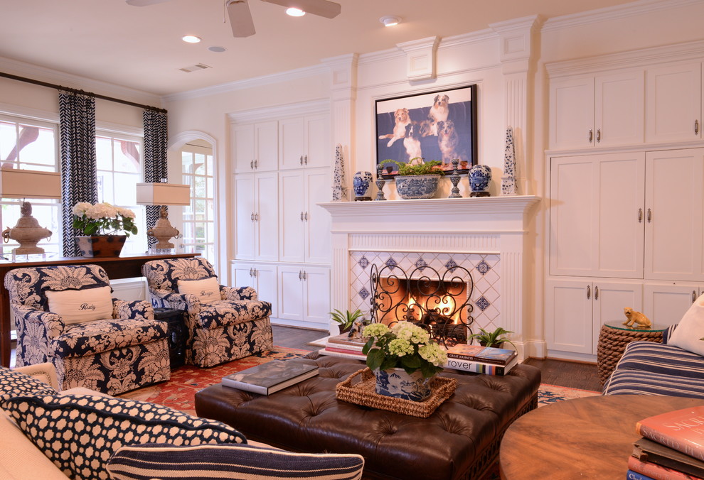 Inspiration for a mid-sized traditional living room in Dallas with white walls, dark hardwood floors, a standard fireplace, a tile fireplace surround, a concealed tv and brown floor.