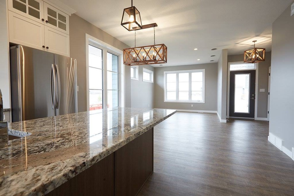 Mid-sized transitional dark wood floor and brown floor eat-in kitchen photo with shaker cabinets, white cabinets, granite countertops and an island