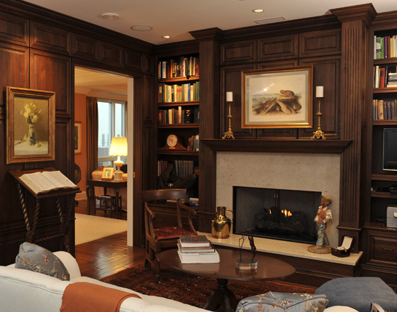 This is an example of a traditional home office in Indianapolis with a standard fireplace and a stone fireplace surround.