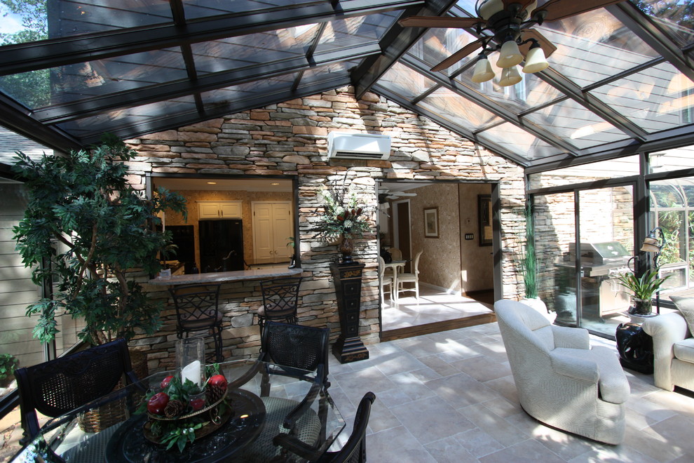 This is an example of a mid-sized traditional sunroom in St Louis.