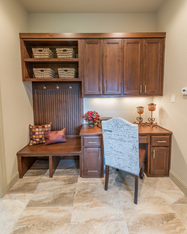 Small country home office in Austin with beige walls, porcelain floors, no fireplace and a built-in desk.