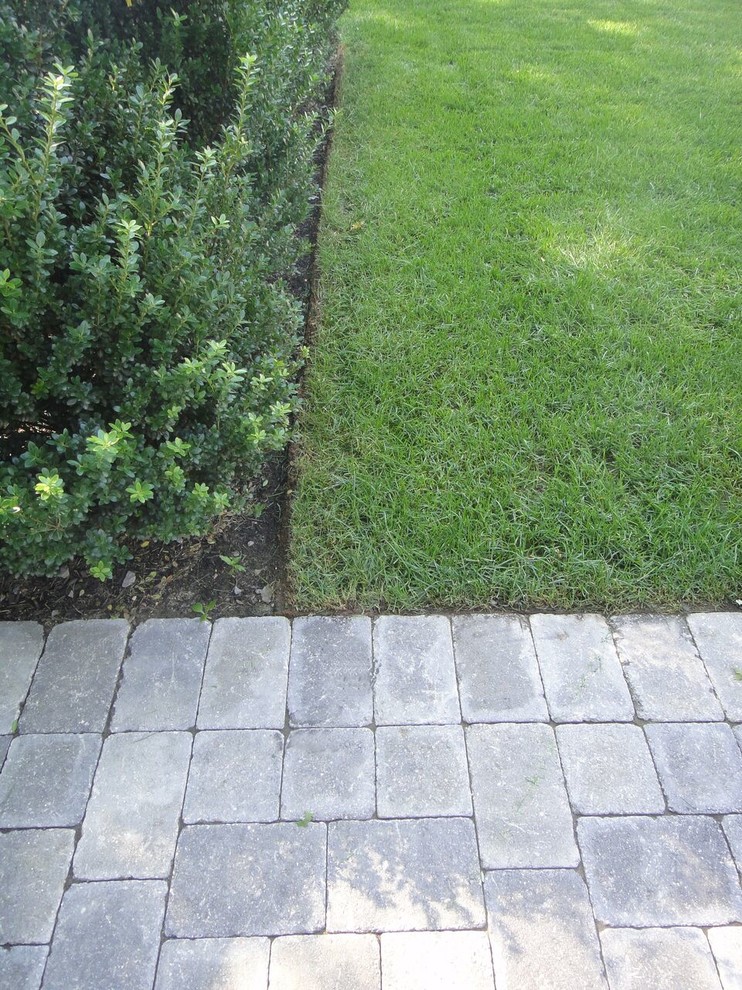 Inspiration for a large traditional backyard partial sun garden in Boston with concrete pavers.