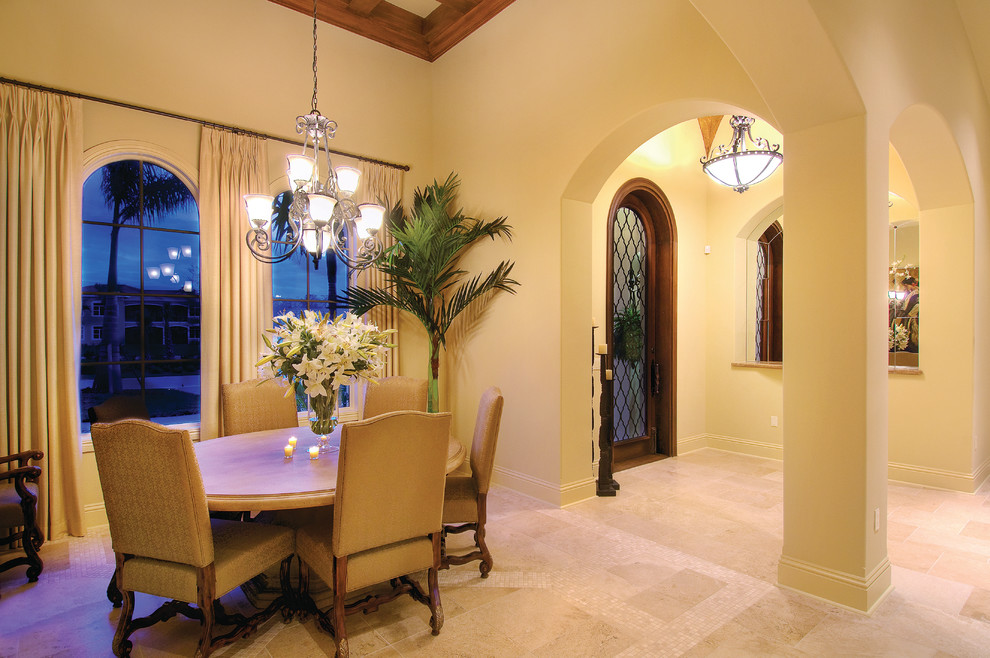 Design ideas for a large mediterranean open plan dining in Miami with beige walls, travertine floors and no fireplace.