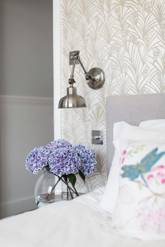 Inspiration for a medium sized contemporary master bedroom in London with grey walls, carpet, a standard fireplace and a stone fireplace surround.