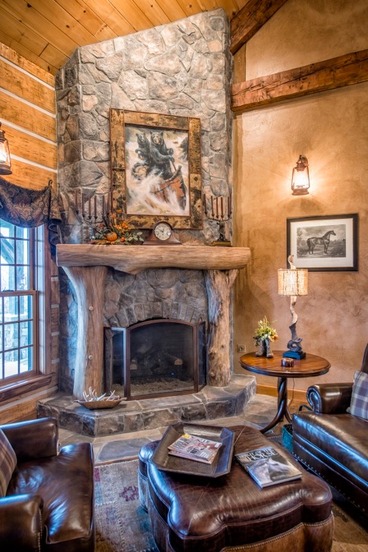 Photo of a small open concept living room in Other with a corner fireplace and a stone fireplace surround.