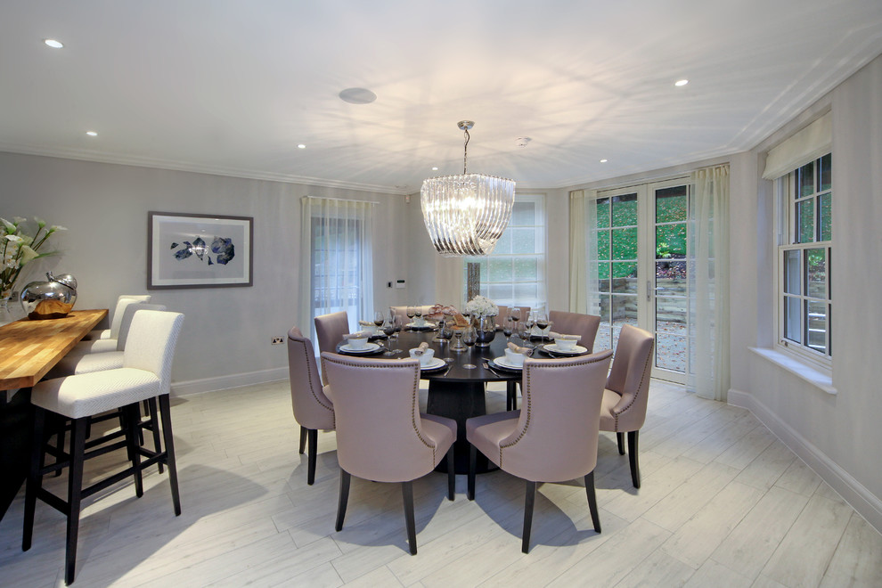 Transitional kitchen/dining combo in London with grey walls, painted wood floors and no fireplace.