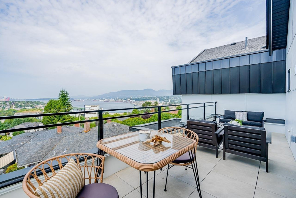 Example of a mid-sized transitional glass railing balcony design in Vancouver with a bbq area and no cover