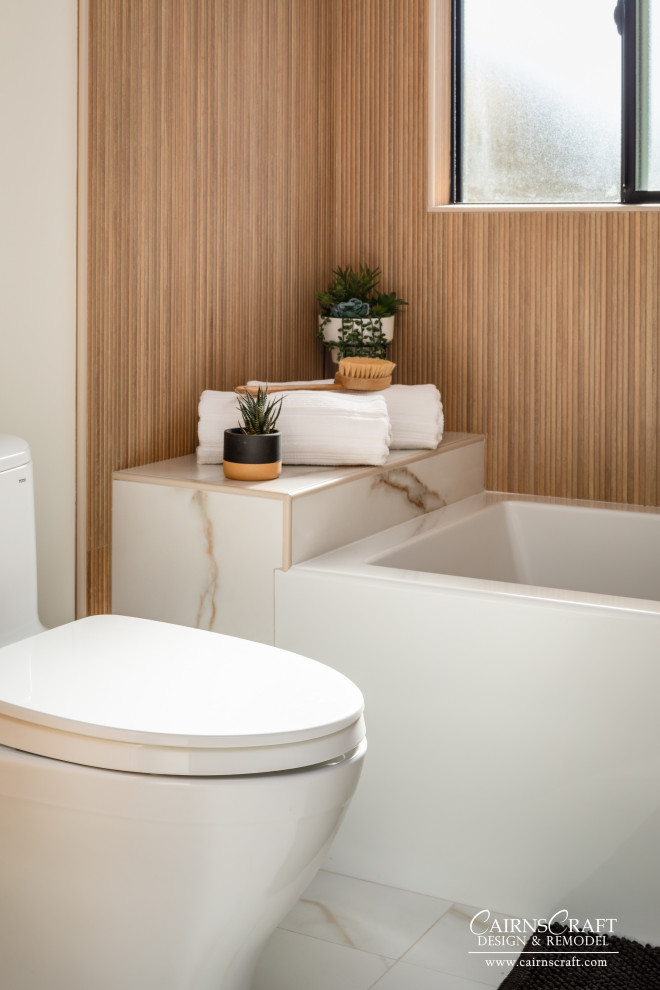 Design ideas for a mid-sized master bathroom in San Diego with white cabinets, a shower/bathtub combo, a two-piece toilet, beige tile, white walls, an integrated sink, engineered quartz benchtops, white floor, white benchtops, a niche, a single vanity, a floating vanity, flat-panel cabinets, an alcove tub, wood-look tile, porcelain floors and an open shower.