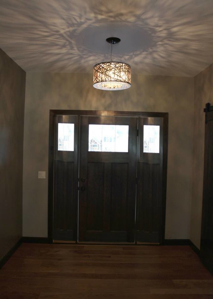Mid-sized transitional medium tone wood floor entry hall photo with beige walls and a dark wood front door