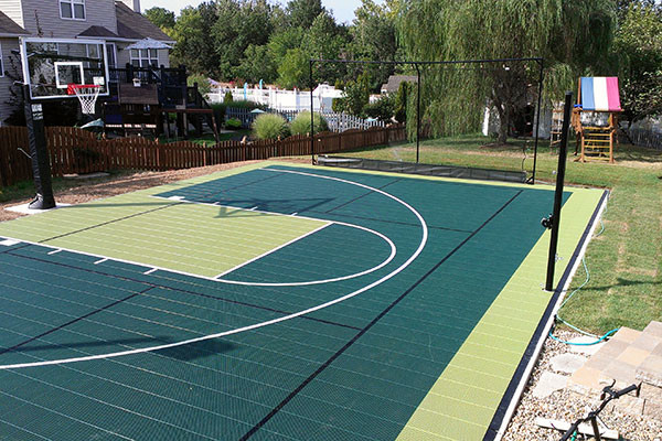 Mid-sized traditional backyard full sun outdoor sport court in St Louis with with outdoor playset for spring.