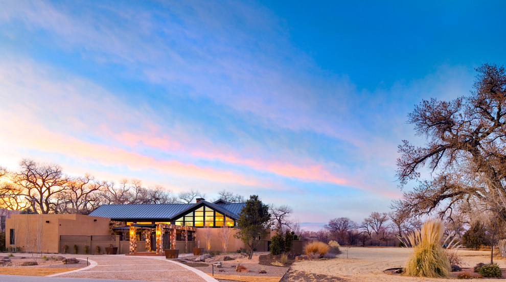 Inspiration for an expansive contemporary two-storey brown exterior in Albuquerque with stone veneer.