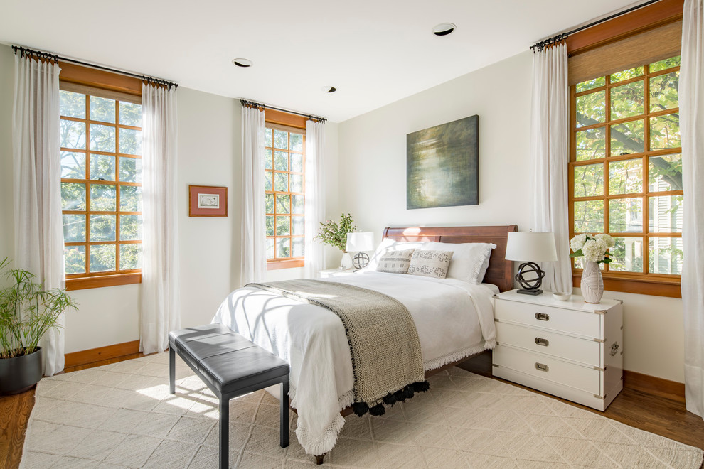 Mid-sized transitional master medium tone wood floor and brown floor bedroom photo in Boston with white walls and no fireplace
