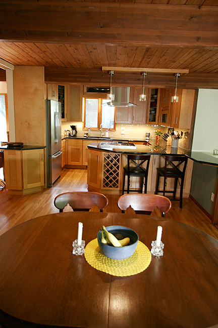 Inspiration for a small transitional l-shaped porcelain tile eat-in kitchen remodel with shaker cabinets, light wood cabinets, granite countertops, beige backsplash, glass tile backsplash, stainless steel appliances and a peninsula