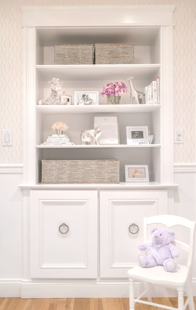 This is an example of a mid-sized transitional nursery for girls in New York with white walls and carpet.