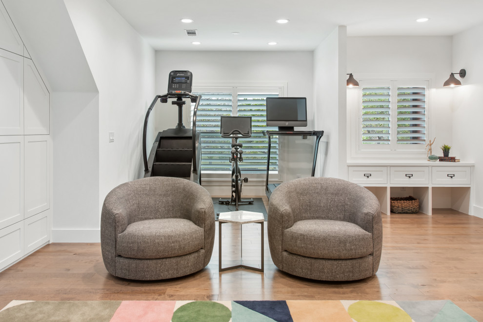 Multiuse home gym - mid-sized transitional medium tone wood floor multiuse home gym idea in Dallas with white walls