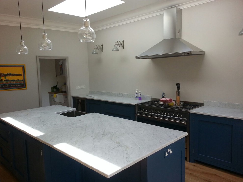 Large traditional kitchen in London with a farmhouse sink, quartzite benchtops and with island.