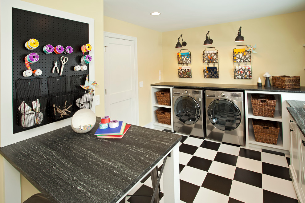 This is an example of a transitional laundry room in Minneapolis with yellow walls and multi-coloured floor.