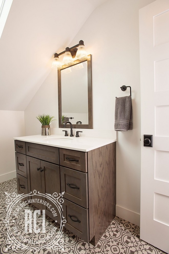 Design ideas for a mid-sized country 3/4 bathroom with shaker cabinets, brown cabinets, a one-piece toilet, white walls, linoleum floors, an undermount sink, engineered quartz benchtops, black floor, a shower curtain and an alcove tub.