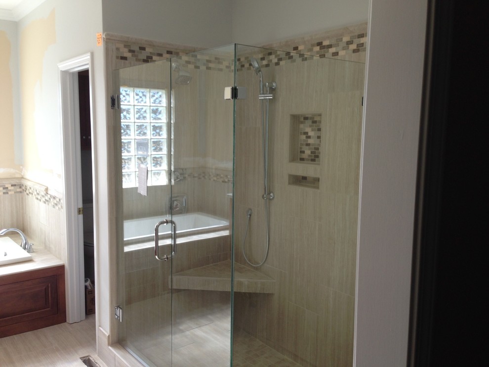 Drop-in bathtub - mid-sized transitional master beige tile and porcelain tile porcelain tile drop-in bathtub idea with raised-panel cabinets, dark wood cabinets, an undermount sink and marble countertops
