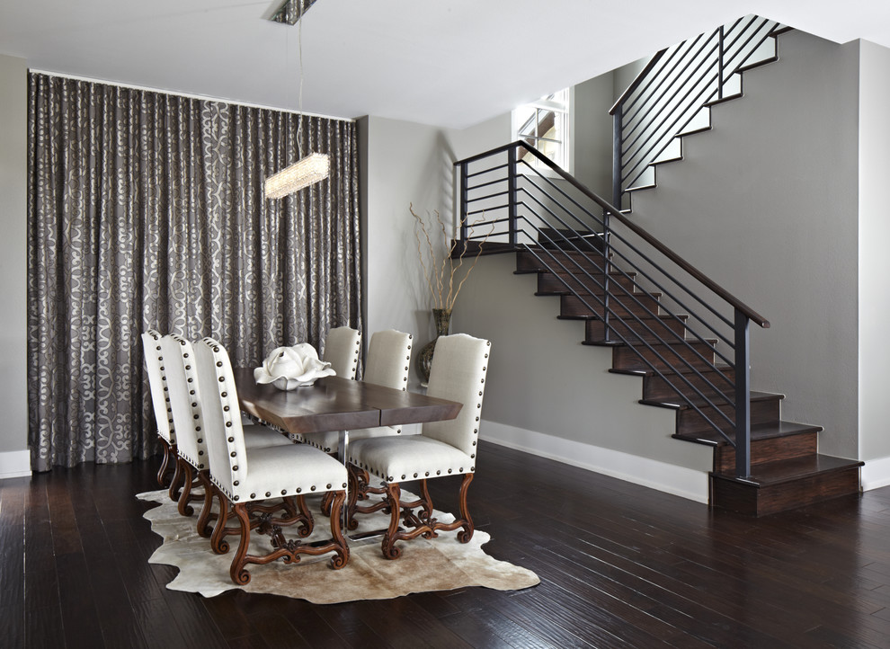This is an example of a contemporary dining room in Austin with grey walls and dark hardwood floors.