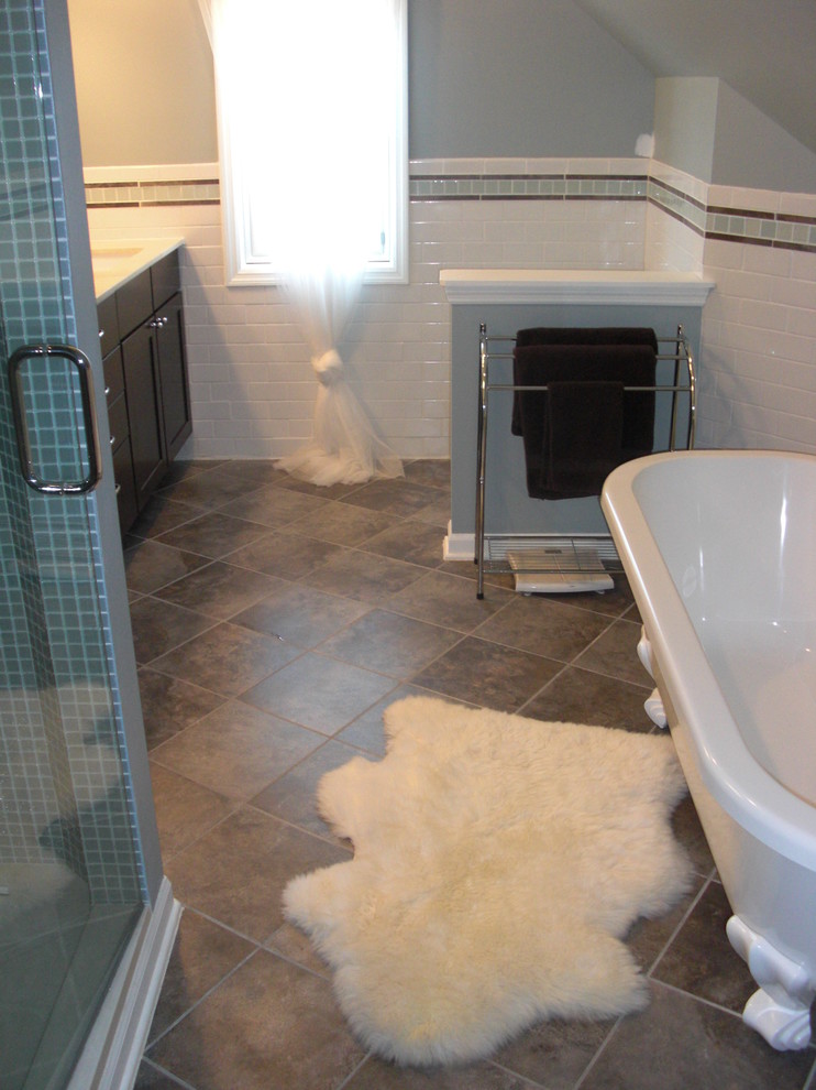 Design ideas for a contemporary master bathroom in Milwaukee with an undermount sink, shaker cabinets, dark wood cabinets, quartzite benchtops, a claw-foot tub, an alcove shower, ceramic tile, grey walls and porcelain floors.